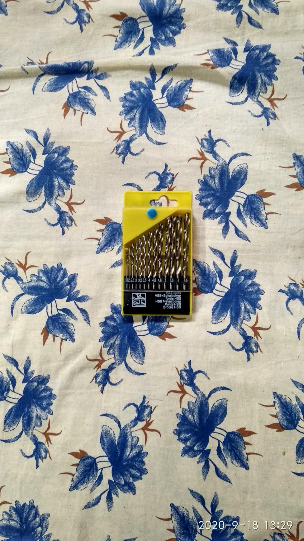 Pack of drill bits on a floral fabric background