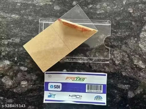 A clear plastic card holder or sleeve containing a brown kraft paper envelope, placed on a dark speckled countertop above a purple and white FRITAG SBI product tag.