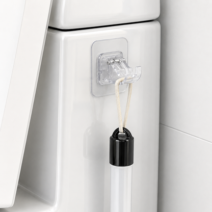 Clear adhesive hook with a black and clear bottle attached to a white surface.