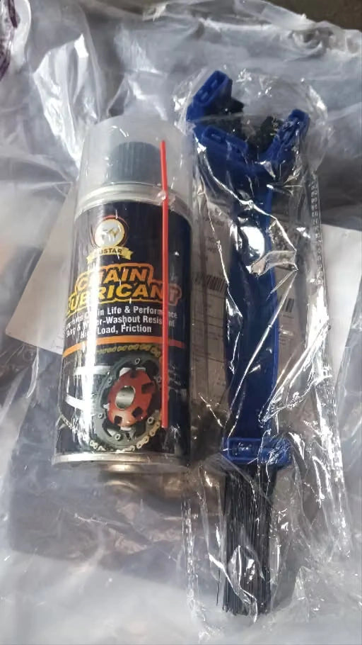 A can of chain lube and a blue chain tensioner wrapped in clear plastic packaging.