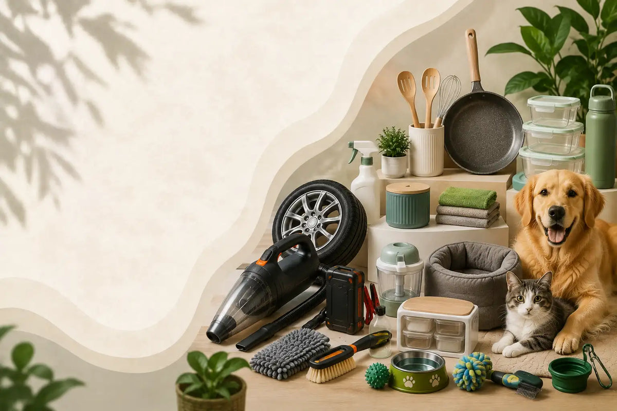 A styled tabletop scene with assorted home and pet-care items arranged on a cream wavy backdrop, including a handheld vacuum, pet toys, bowls, a pet bed, a frying pan, plants, and a golden retriever and tabby cat sitting on the right side.