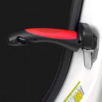 Close-up of a car seat belt buckle with red padding on a black car interior.