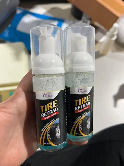 Two bottles of Tire Retrad product held in a hand with a blurred background.