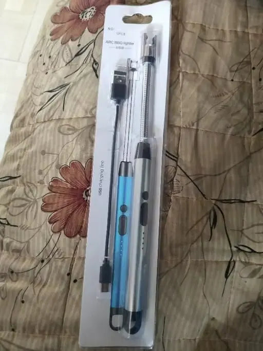 A USB-powered pen light and multi-tool accessory set in its original retail blister packaging, placed on a patterned beige fabric background.